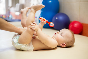 Pediatric Physical Therapy - an infant exercising on a table