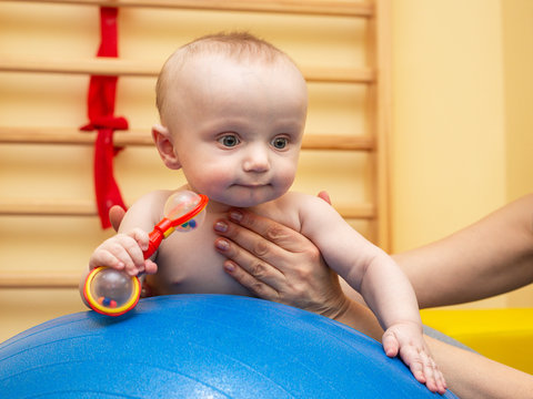 Pediatric Physical Therapy - An Infant Exercising On A Ball