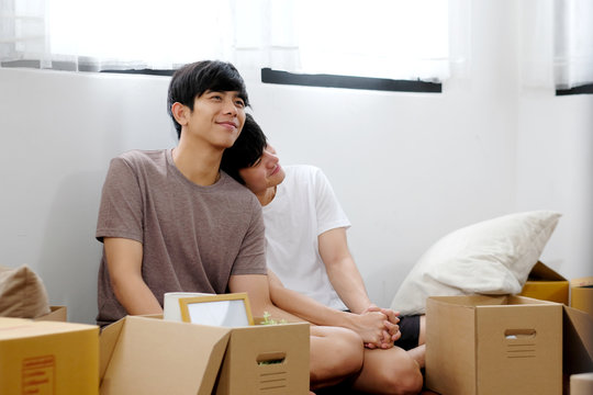 Asian Homosexual Male Lgbt Couple, Young Asian Gay Man Moving Into New Home, Unpacking With Happiness While Sitting In Home Living Room, Homosexual And Lgbt Lifestyle Concept