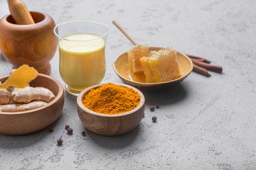 Healthy drink golden turmeric milk in glass cup