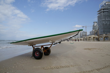 sup board or paddle board on a transport trolley on a beach in the sand