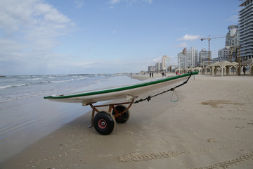 sup board on a transport trolley on a beach in the sand