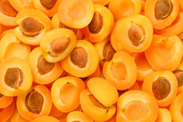 Ripe juicy orange apricots slices fruit background.