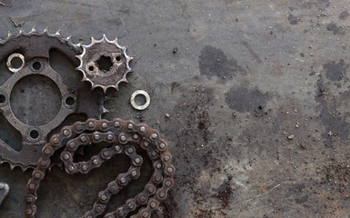 roller chains with sprockets for motorcycles on old black  background. top view