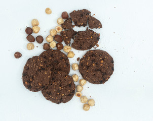 Chocolate cookies for breakfast with mint and hazelnut and a glass of milk on a gray table