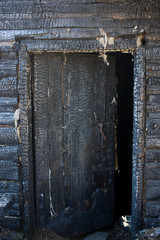 Black background. Burnt wooden Board texture. Burned scratched hardwood surface. Smoking wood plank background. Burned wooden grunge texture Space for text.