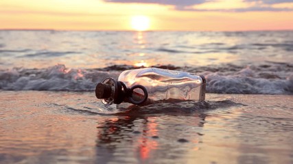 Message in the bottle against the Sun setting down