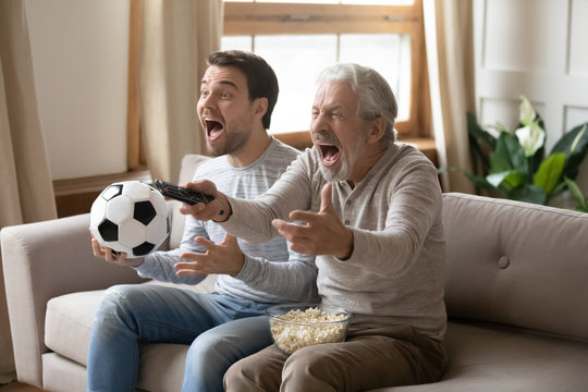 Overjoyed Two Generations Family Football Fans Supporting Favorite Sport Team.