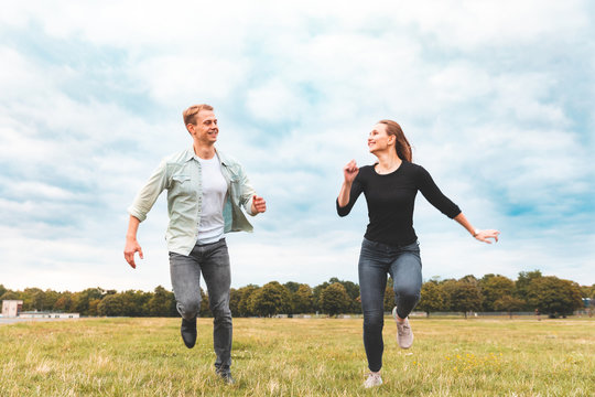 Happy Couple Running And Having Fun Together At Tempelhof  Park