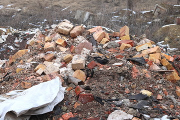 Construction waste with elements of various dismantled and destroyed old structures at municipal landfill