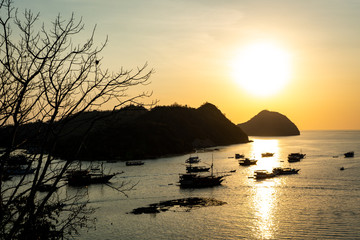 sunset over the sea with boats 