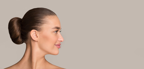 Hairstyle concept. Woman with dark hair in bun
