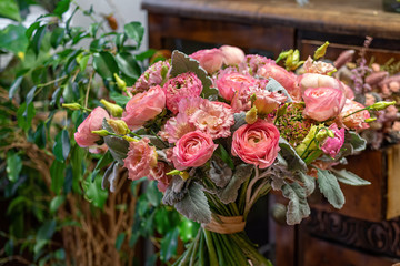 Beautiful multi-colored bouquet of mixed roses and other flowers in a shop. Fresh cut flowers.