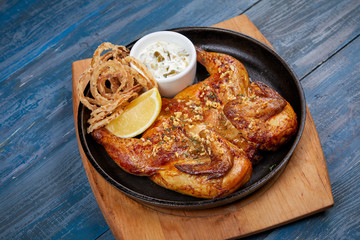roasted chicken with sauce and lemon