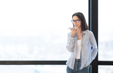 Business girl using mobile voice recognition function