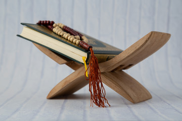 Quran - holy book of Muslims religion, Concept: open book holy prayers for god,  Friday In the month of Ramadan  religion Islamic worshiping faith and learn koran and rosary put on wooden  boards 