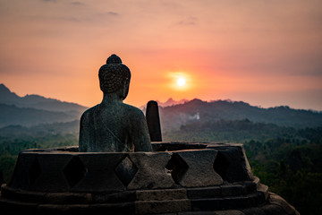 buddha statue at sunset borobodur indonesia