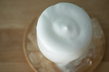 Glass of fresh milk with milk froth lava