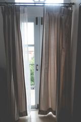 Naklejka na ściany i meble Brown curtains in a sliding door