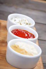 different sauces on the wooden tray