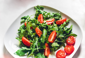 fresh vegetable salad with cherry tomatoes and arugula