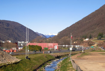 a stream flows parallel to a stretch of motorway between Mendrisio and Lugano in the Canton of Ticino. Switzerland