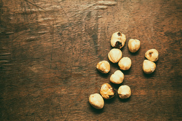 Still life, toasted hazelnuts on wooden board
