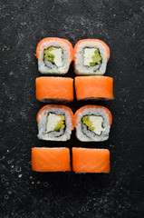 Traditional sushi - Philadelphia with salmon, avocado and cheese. Japanese cuisine. Top view.