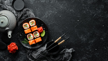 Sushi set with caviar, avocado and salmon. Asian cuisine. Top view. Free space for your text.