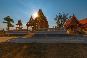 The sun goes down behind the temple at Wat Prathumthong. Ban Nong Bua Noi, Suwannakhuha, Nong Bua...
