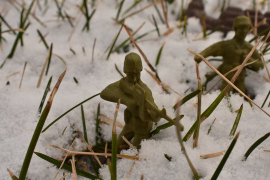 Miniature Army Men Marching Through the Snow