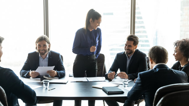 Happy businesswoman manager laughing in boardroom at meeting.