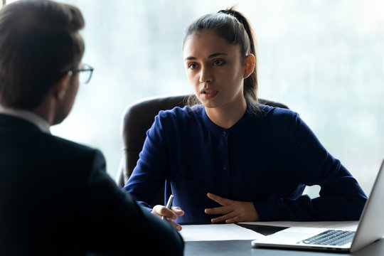 Attractive businesswoman hr interviewing new applicant using cv and laptop.