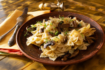 Penne pasta with mushrooms and thyme close up