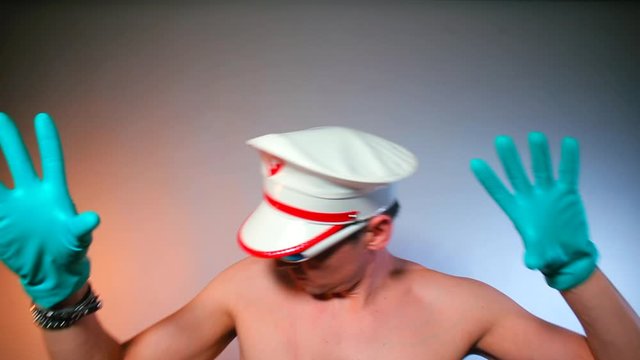 The guy with glasses and a cap makes dance moves