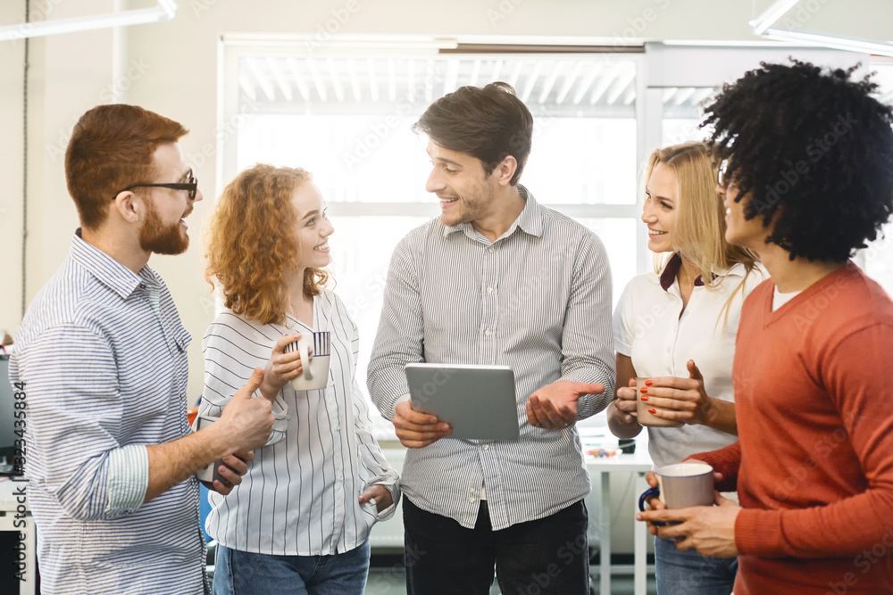 Poster manager having informal briefing with employees in office