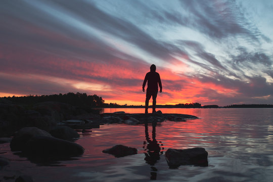 silhouette of man on the beach at sunset