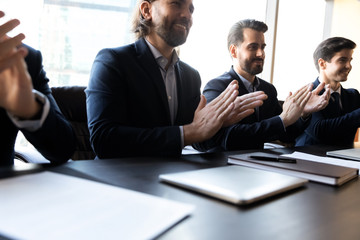 Close up happy clap hands businessmen with applicant cv.