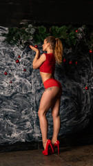 Obraz na płótnie Canvas Woman in red underwear with lollipop