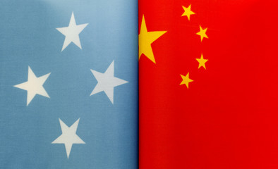 fragments of national flags of the Federated States of Micronesia and China close-up