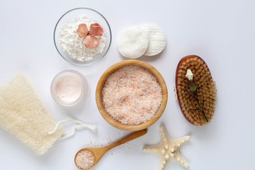 Obraz na płótnie Canvas Organic cosmetics for skin care: sea salt, alginate mask, face cream on white background, top view