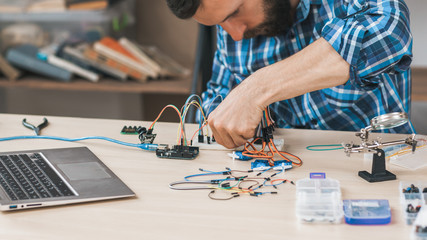 Modern technology, diy product engineering. Technician creating electronic construction at lab.