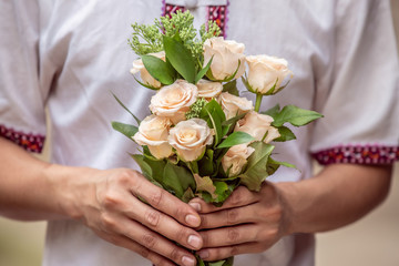 A man holding a bouquet of roses, Selective focus Holiday.