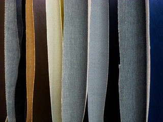 Multicolored faux leather samples in vertical position. Woven texture and background