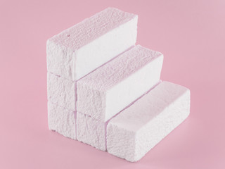 Sweet pink marshmallow rectangular shape in the form of a geometric shape. Marshmallows with the taste of cranberries, strawberries or other berries