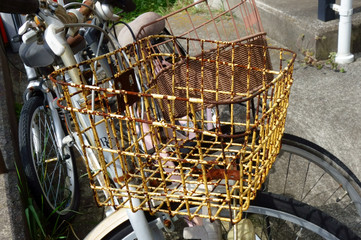 路上に打つ捨てられた古い自転車の買い物籠