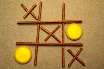 Game tic tac toe pretzel sticks and macaroons