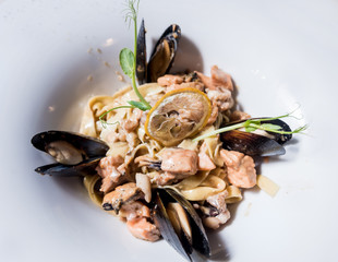 Pasta with mussels in pan. Italian style cuisine. Restaurant.