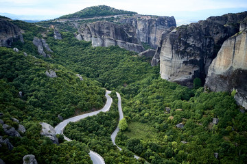 Legendary aerial drone view of ancient monasteries and breathtaking picturesque valley and landmark canyon of Meteora, Greece, Unesco