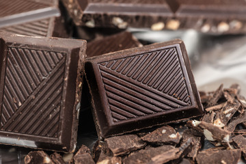 Chocolate bar pats pieces background with almond nut